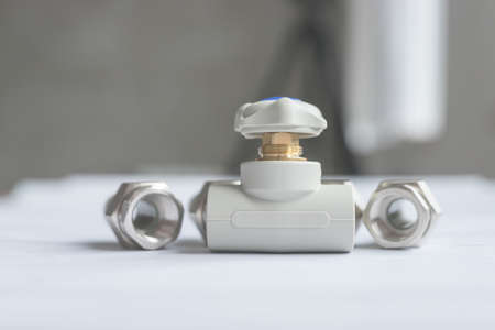 One modern polypropylene water tap with metal American couplings isolated on white background. Close-up of tap with blurred backgroundの写真素材