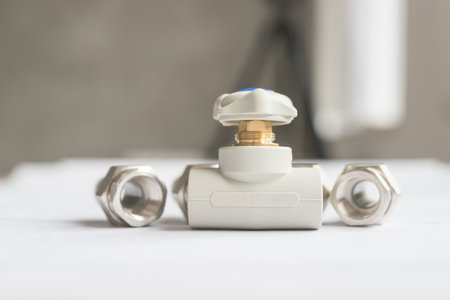 One modern polypropylene water tap with metal American couplings isolated on white background. Close-up of tap with blurred backgroundの写真素材