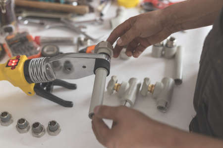 Man keep soldering iron for polypropyleneの写真素材