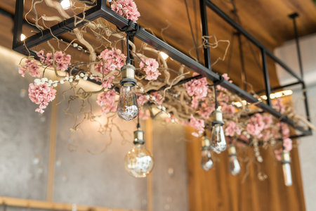 Decor with floral arrangement and Edison lampsの写真素材