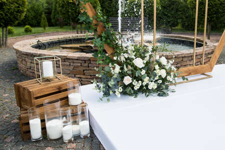 Close up of wedding ceremony with arch in rustic style with fresh flowersの写真素材