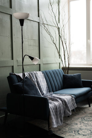 Interior of living room with blue sofa and black lamp, stock photo