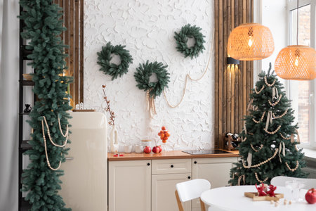 Beautiful new year interior with decorated kitchen and Christmas tree on wall
