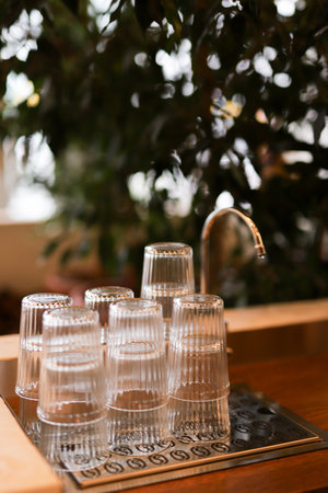 Close up of a row of glasses on a bar counter, shallow depth of field