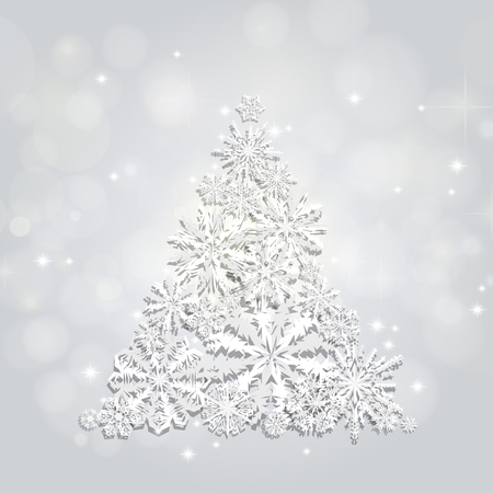 Christmas and New Years silver background with Christmas Tree made of cutout paper snowflakesの写真素材