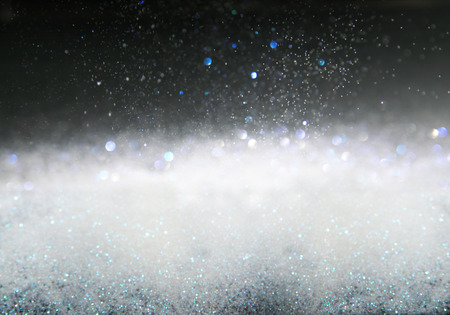 Glitter vintage lights background, the silver and black. Image defocused.の写真素材