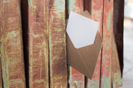 Old rusty iron mailbox with blank paper and letter.の写真素材
