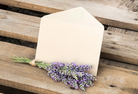 Flowers and envelope on wooden backgroundの写真素材