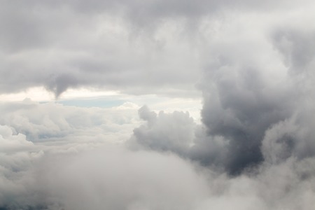 Closeup large gray clouds in the sky the view from the airplane window.の写真素材