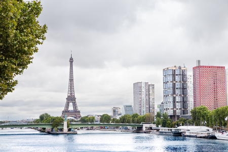 Eiffel Tower, Seine river and Statue of Liberty in Paris, France. Boats on Seine river.の写真素材