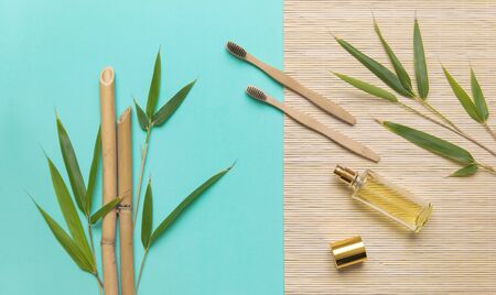 Glass bottle with bamboo extract for medicine aromatherapy, cosmetology, body care. Bamboo mat with esential oil, health jar and green bamboo leaves.の写真素材