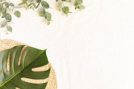 Natural materials eco style with tropical leaves on a light fabric background.の写真素材