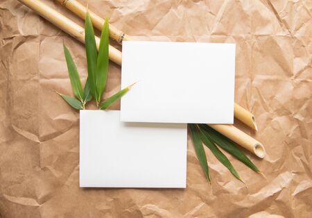 Top view banner of white envelope over bamboo branchers and creased paper. Eco life stile composition with copy space.の写真素材