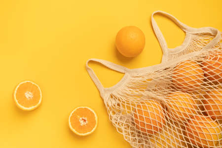 Fresh oranges in a eco bag. Cutted citrus fruit for healthly food.