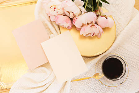 Wedding greeting card concept. Top view mockup on wooden background with peonies flowers. Flat lay...
