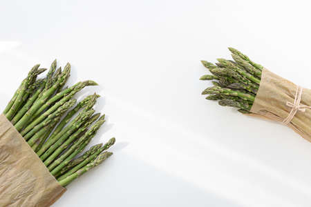 Raw stems asparagus tied with twine. Vegetable food isolated on white background.の写真素材