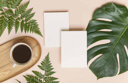 Styled summer wedding mockup. Blank greeting and invitation card. Green tropical leaves with...