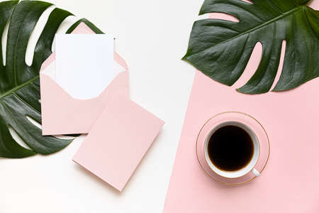 Styled summer wedding desktop stationery mockup. Blank greeting and invitation card. Green tropical leaves with empty space.の写真素材