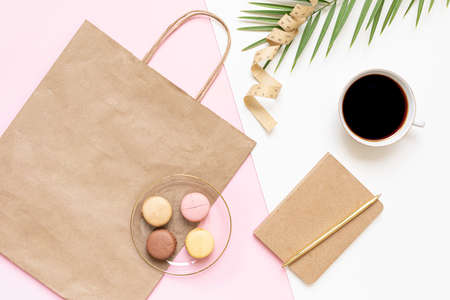 Flat Lay shopping concept with paper bag and tropical leaves. Elegant composition with elegant accessories.の写真素材