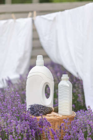 Fabric softener with lavender scent. Fragrance in a field with purple flowers.