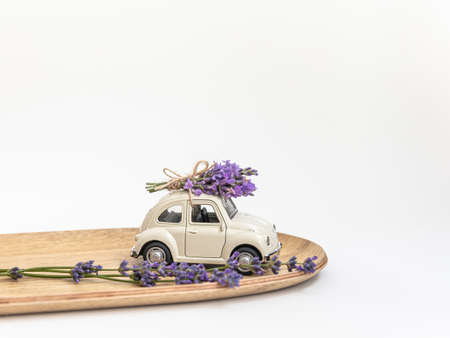 A small car and a bouquet of lavender. Delivery and gifts concept.の写真素材