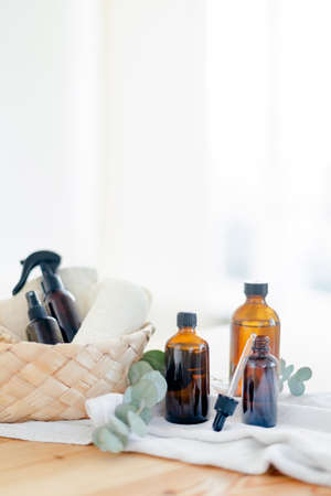 Essential oils in glass dark bottle. Skin and body care treatment concept. Eucalyptus branch.の写真素材