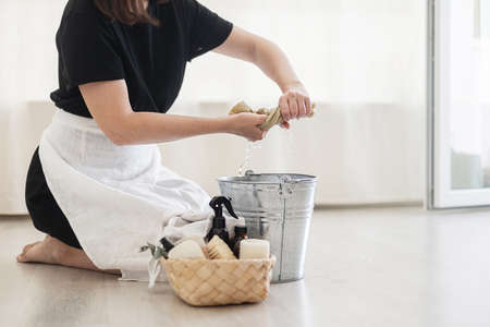 House keeping concept. Woman wiping floor. Woman doing chores at home.の写真素材