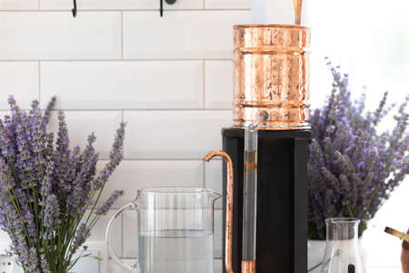 Distillation of lavender essential oil. Copper alambic in a Scandinavian interior. Chemical laboratoryの写真素材