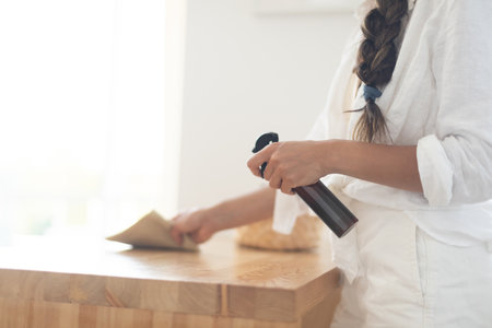Young woman cleans the kitchen with eco products.の写真素材