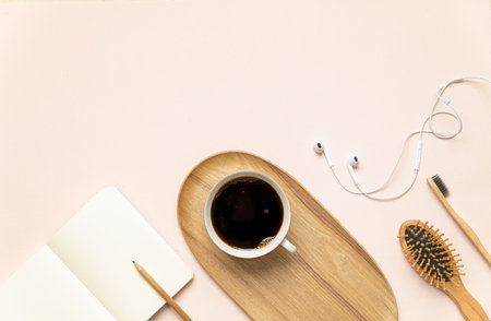 Flat lay fashion concept with copy space. Morning accessories on pink background and dried tropical leaf.の写真素材