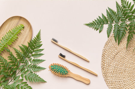Flat lay fashion concept with copy space. Morning accessories on pink background and dried tropical leaf.の写真素材