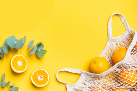 Fresh oranges in a eco bag. Cutted citrus fruit for healthly food.の写真素材