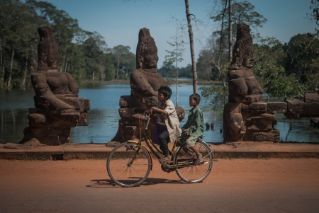 Two boys on a bicycle at the entrance of Angkorのeditorial素材