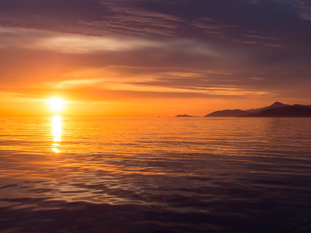 Beautiful sunset in Adriatic sea, Montenegro, captured from a sailing boatの写真素材