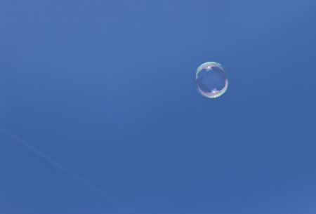Soap bubble before bright blue skyの写真素材