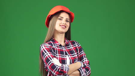 Studio shot of a beautiful cheerful young female construction worker engineer wearing protective...