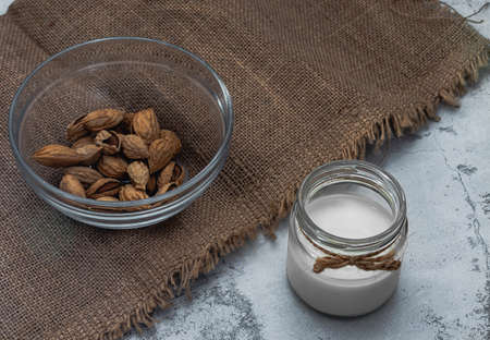 Alternative vegan milk and almond on jute. Healthy organic food. Zero lactose. World Vegetarian Day....