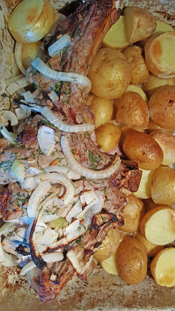 Pork rib, baked in the oven with potatoes and onionsの写真素材