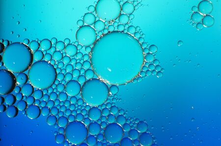 art photo abstract background of bubbles of different sizes on a blue backgroundの写真素材