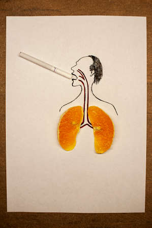 art photo about the dangers of smoking with a painted man with lungs from an orange and a cigarette