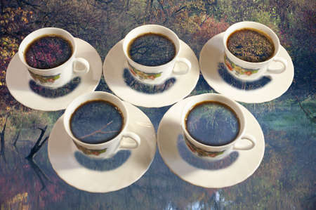 photo double digital exposure with five cups of coffee and an autumn lakeの写真素材