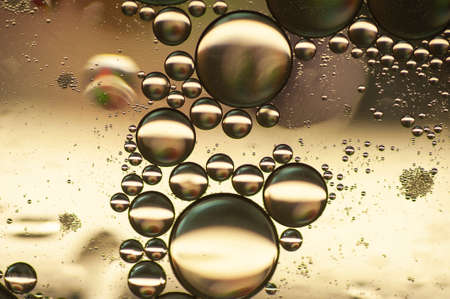 photo abstract background of oil bubbles in golden tonesの写真素材