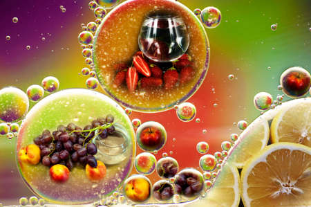 multi-colored photo double exposure of fruit apples grapes lemon nectarine and oil drops in water for backgroundの写真素材