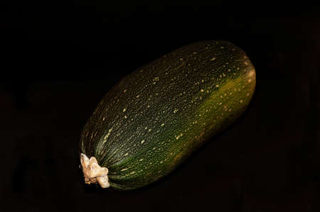 horizontal photo of a zucchini close-up on a black backgroundの写真素材
