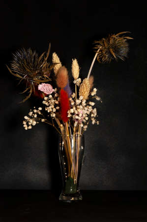 vertical photo of a bouquet of dried flowers close-up on a black backgroundの写真素材