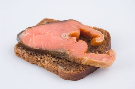 A slice of red fish on piece of breadの写真素材