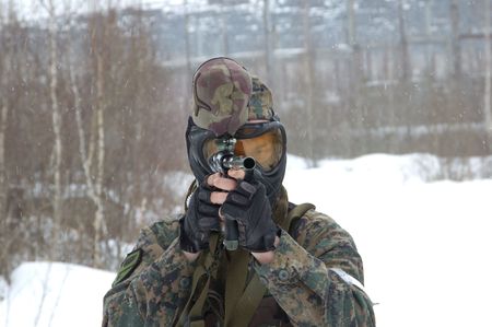 armed men in a camouflage play a paintballの写真素材
