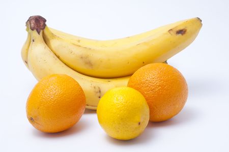 Cluster of ripe bananas a lemon and two orangesの写真素材