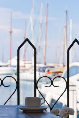Coffee cup on a table of seaside cafeの写真素材
