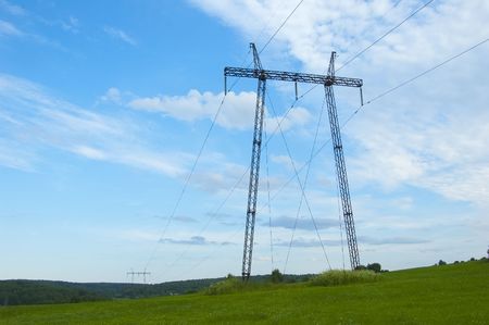 Transmission line against the blue sky